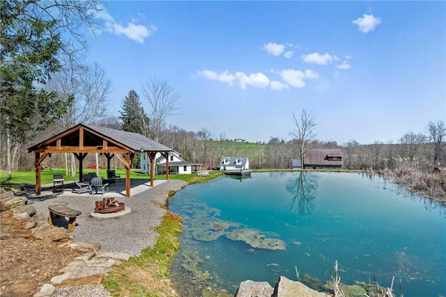 view of pool featuring a pool, a water view, a patio, an outdoor fire pit, and a gazebo