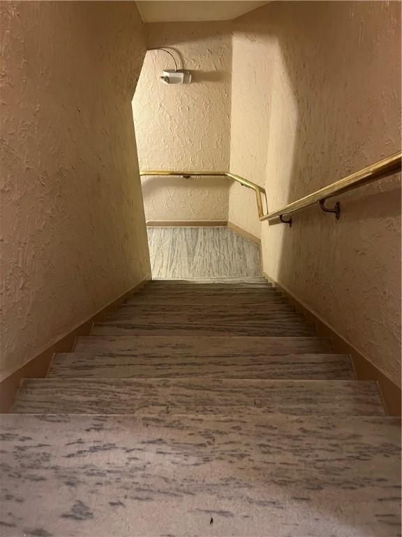 166 N Dithridge St Unit L2, Oakland, PA 15213 - stairway featuring a textured wall and wood finished floors