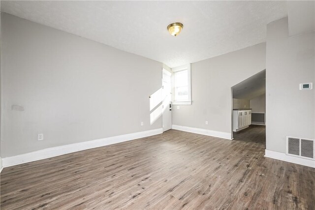 2106 Sarah St, South Side, PA 15203 - unfurnished living room with visible vents, baseboards, and wood finished floors