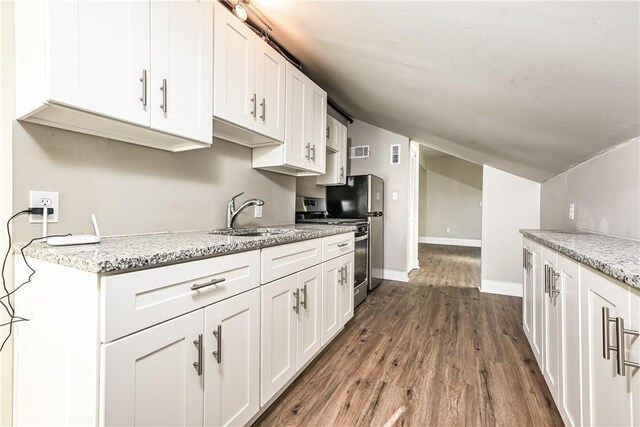 2106 Sarah St, South Side, PA 15203 - kitchen featuring white cabinets, dark wood finished floors, stainless steel gas range oven, a sink, and light stone countertops