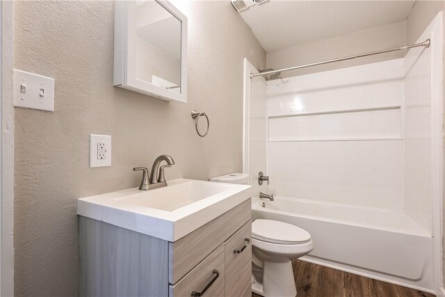 2106 Sarah St, South Side, PA 15203 - full bath featuring shower / washtub combination, wood finished floors, a textured wall, toilet, and vanity