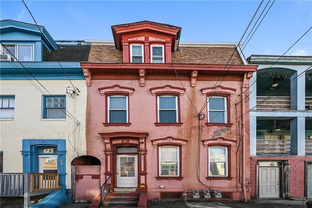 2106 Sarah St, South Side, PA 15203 - view of front of home featuring brick siding, a shingled roof, and mansard roof