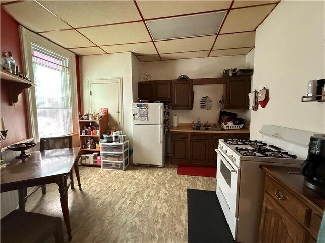 2106 Sarah St, South Side, PA 15203 - kitchen with light wood-type flooring, a paneled ceiling, white appliances, and a sink