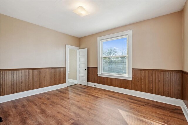 400 Allison Ave, City Of Washington, PA 15301 - empty room featuring baseboards, a wainscoted wall, wood finished floors, and wooden walls