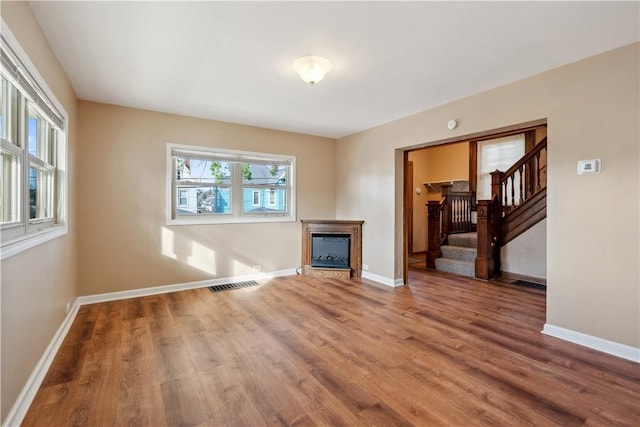 400 Allison Ave, City Of Washington, PA 15301 - unfurnished living room featuring baseboards, a glass covered fireplace, wood finished floors, and visible vents