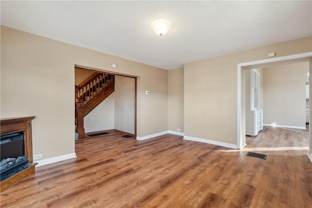 400 Allison Ave, City Of Washington, PA 15301 - unfurnished living room featuring stairs, wood finished floors, visible vents, and baseboards