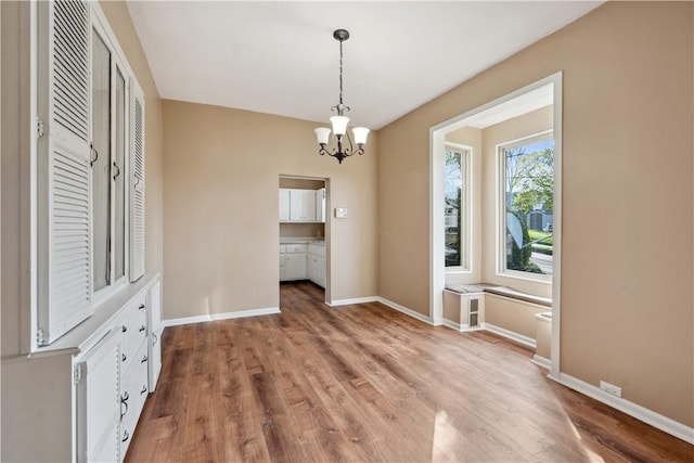 400 Allison Ave, City Of Washington, PA 15301 - unfurnished dining area with an inviting chandelier, light wood finished floors, and baseboards