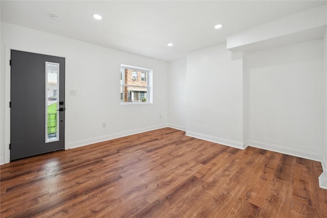 interior space featuring baseboards, wood finished floors, and recessed lighting