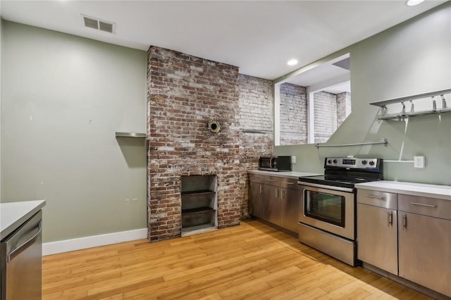 kitchen featuring light wood finished floors, light countertops, appliances with stainless steel finishes, visible vents, and recessed lighting