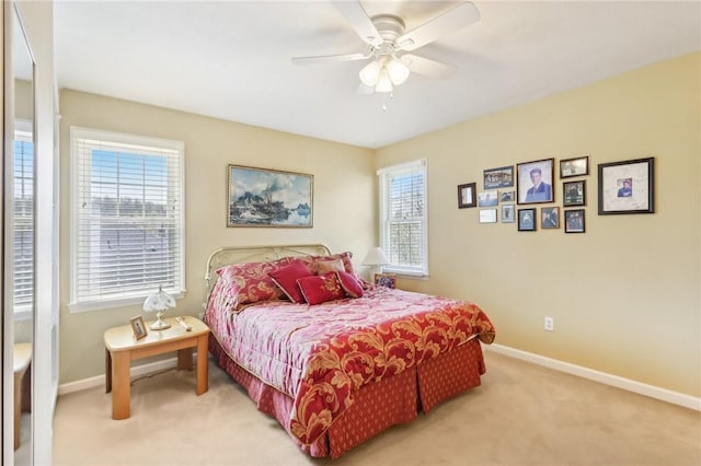 bedroom with baseboards, a ceiling fan, and light carpet