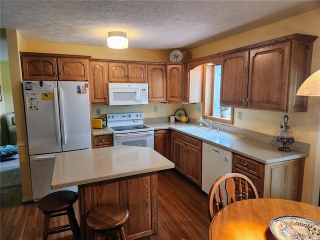 202 Hilltop Dr, Center Twp But, PA 16001 - kitchen with a center island, a textured ceiling, white appliances, light countertops, and dark wood-type flooring
