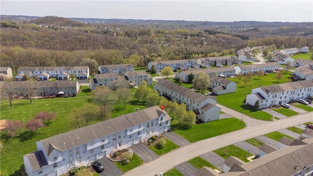 birds eye view of property with a residential view and a wooded view