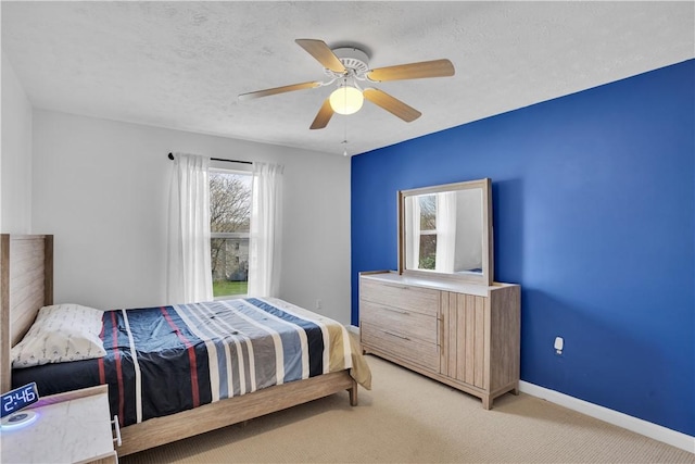 bedroom featuring a ceiling fan, baseboards, and light colored carpet