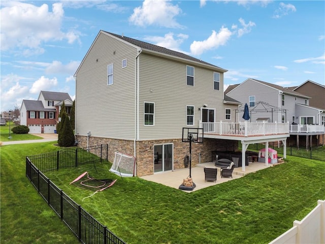 rear view of house with a patio area, a fenced backyard, and a yard