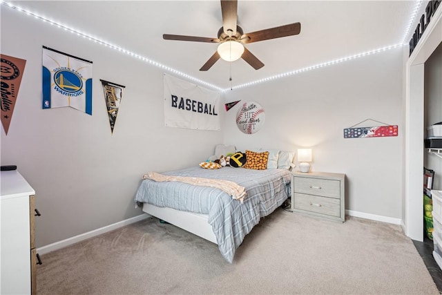 carpeted bedroom with baseboards and ceiling fan