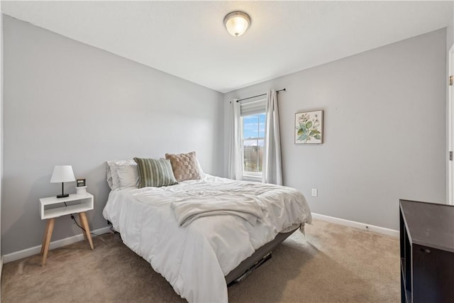 bedroom with baseboards and light carpet
