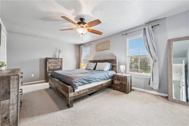 bedroom featuring baseboards, a ceiling fan, and light carpet
