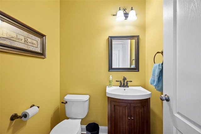 bathroom featuring toilet and vanity