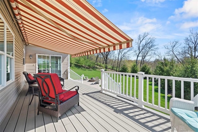 wooden terrace with a yard and outdoor dining area