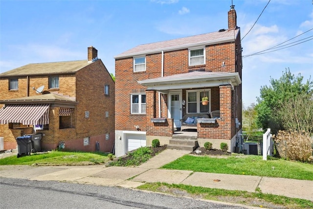 traditional home with central AC unit, a chimney, an attached garage, a porch, and brick siding