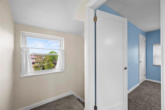 interior space with baseboards and carpet