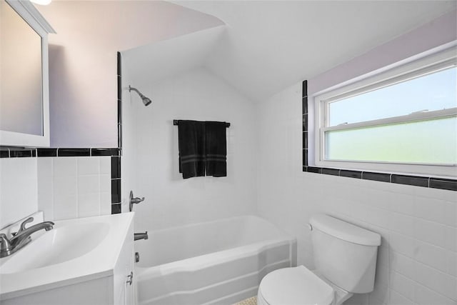 bathroom with tile walls, shower / bathtub combination, vanity, and toilet