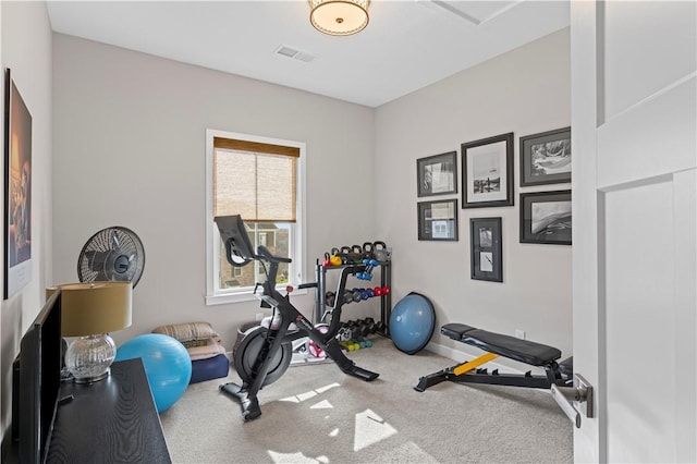 workout area with baseboards, visible vents, and carpet