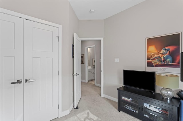 bedroom featuring light carpet and baseboards