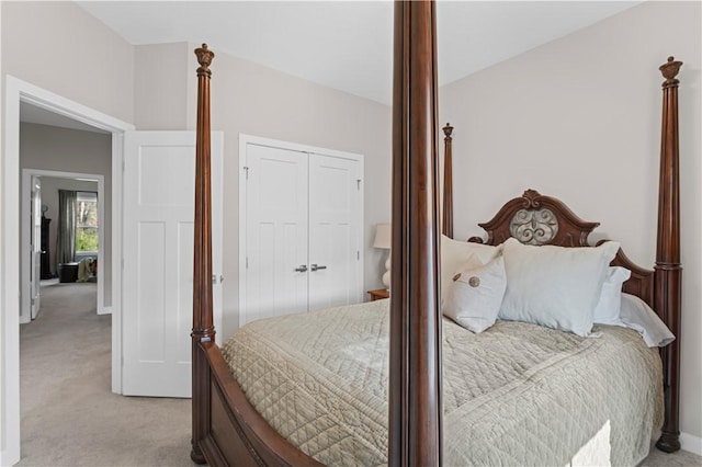 bedroom with light colored carpet and a closet