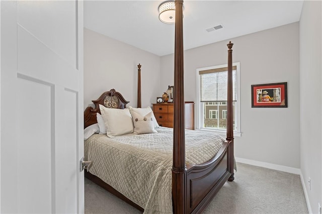 carpeted bedroom with visible vents and baseboards