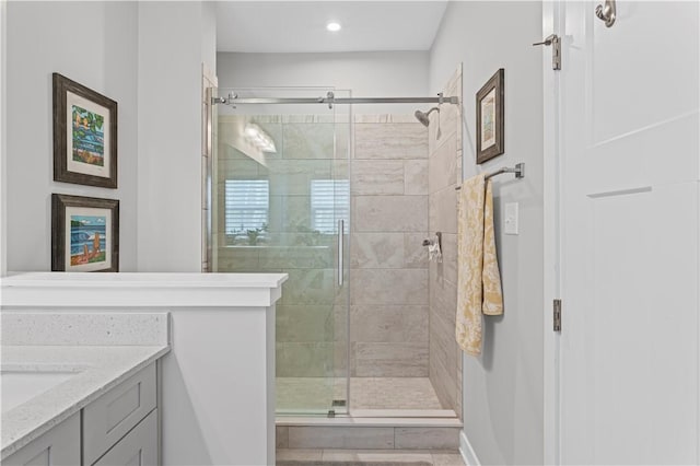 full bath featuring recessed lighting, vanity, and a stall shower