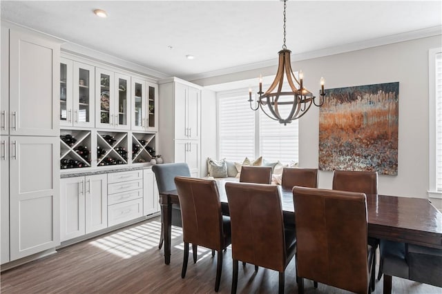dining area with dark wood finished floors, ornamental molding, a notable chandelier, and recessed lighting