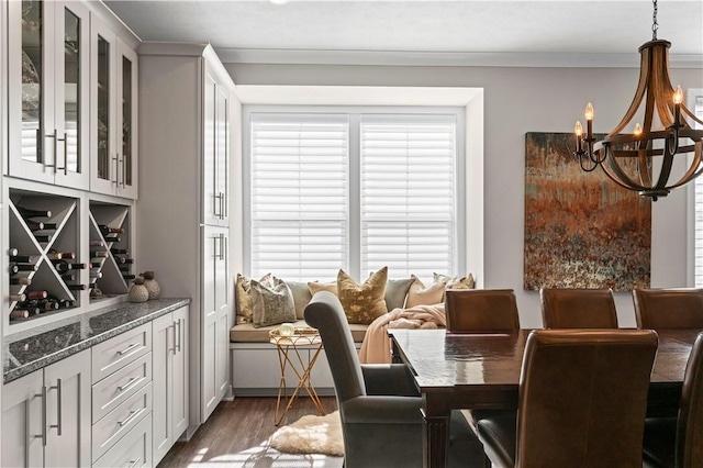 dining room featuring a chandelier, wood finished floors, and ornamental molding