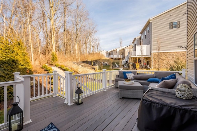 wooden terrace featuring an outdoor living space and a residential view