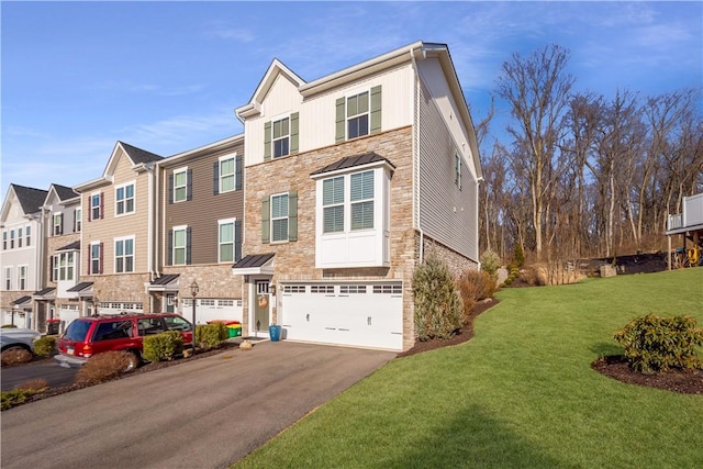 view of front of home featuring board and batten siding, an attached garage, stone siding, and aphalt driveway