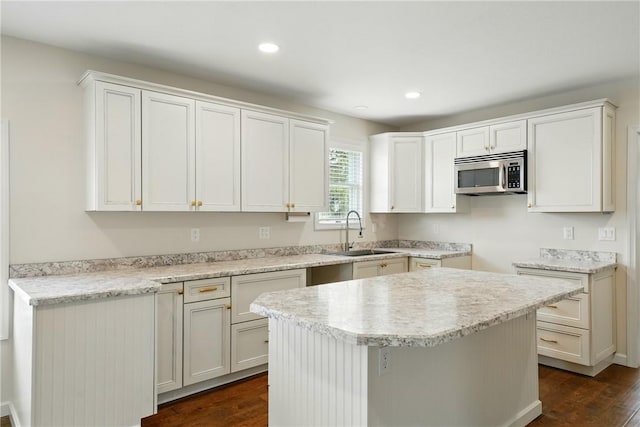 1125 Griswold St, Sharon, PA 16146 - kitchen featuring stainless steel microwave, light countertops, dark wood-style floors, and a sink