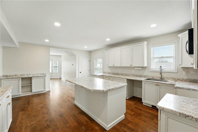 1125 Griswold St, Sharon, PA 16146 - kitchen featuring a center island, white cabinetry, dark wood finished floors, and a sink