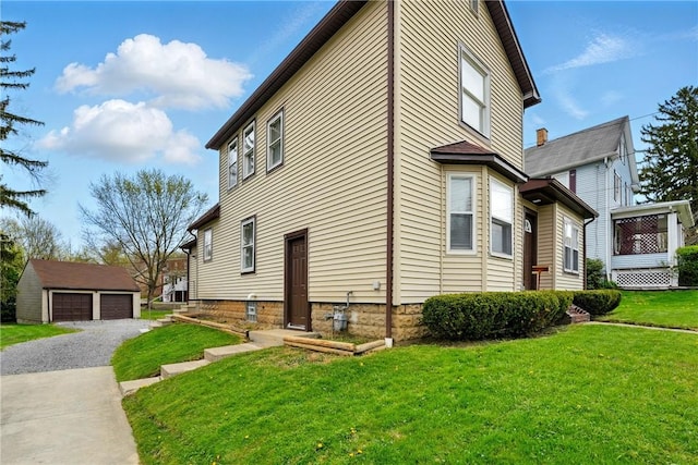 1125 Griswold St, Sharon, PA 16146 - view of property exterior with a lawn, a detached garage, and an outbuilding