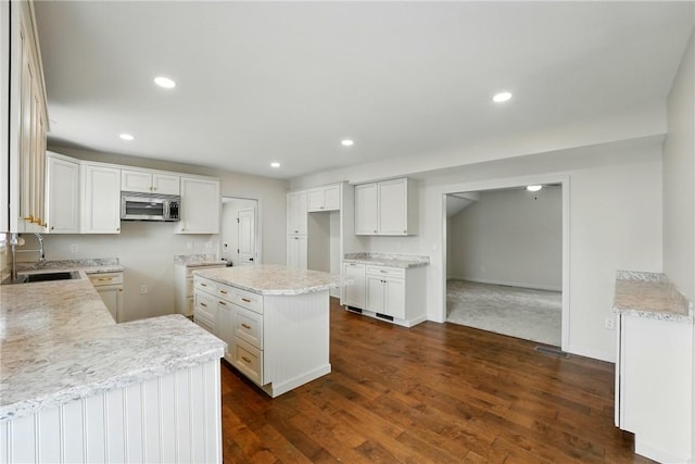 1125 Griswold St, Sharon, PA 16146 - kitchen with recessed lighting, stainless steel microwave, dark wood-style flooring, and a sink