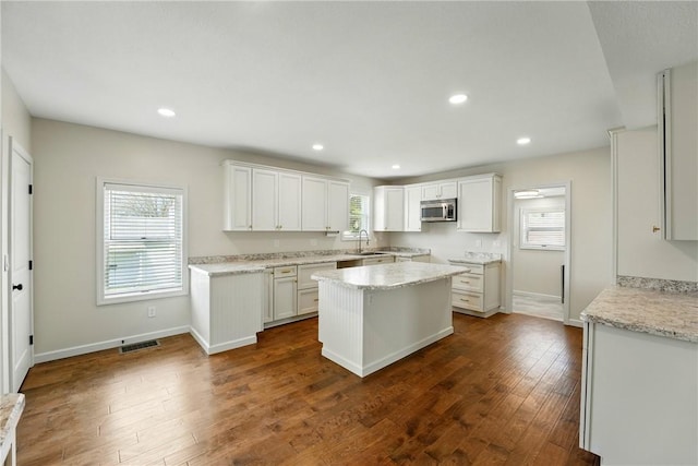 1125 Griswold St, Sharon, PA 16146 - kitchen featuring stainless steel microwave, white cabinets, visible vents, recessed lighting, and dark wood-type flooring