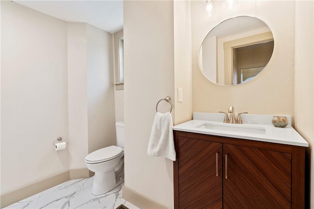 bathroom featuring vanity, baseboards, marble finish floor, and toilet
