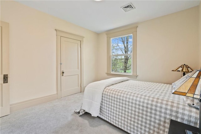 bedroom with visible vents and carpet