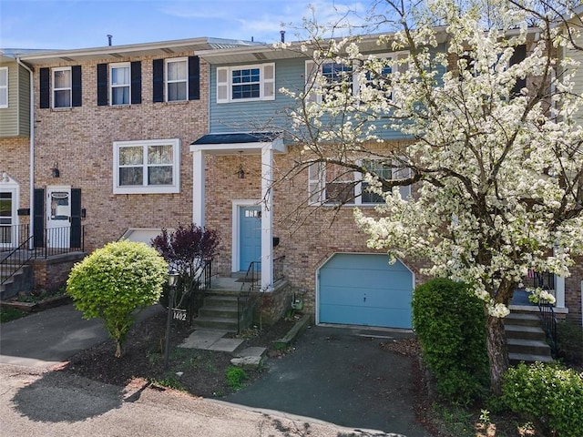 1402 Magnolia Ct, Bethel Park, PA 15102 - view of front facade with brick siding, an attached garage, and driveway