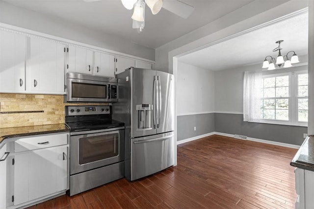 1402 Magnolia Ct, Bethel Park, PA 15102 - kitchen with dark countertops, appliances with stainless steel finishes, white cabinetry, and ceiling fan with notable chandelier