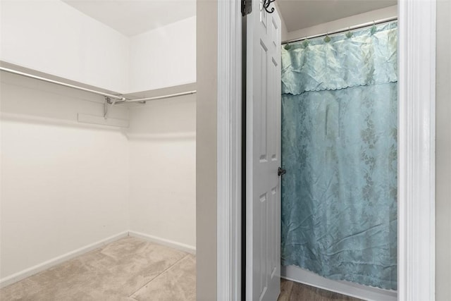 1402 Magnolia Ct, Bethel Park, PA 15102 - full bathroom featuring a walk in closet, baseboards, and a shower with curtain
