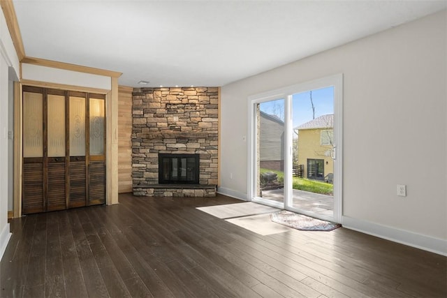 1402 Magnolia Ct, Bethel Park, PA 15102 - unfurnished living room featuring wood-type flooring, a stone fireplace, and baseboards