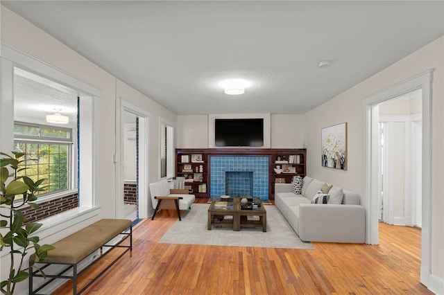 129 S Braddock Ave, Point Breeze, PA 15221 - living room featuring light wood-style flooring and a tile fireplace