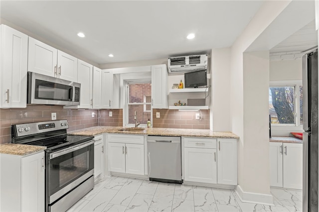 129 S Braddock Ave, Point Breeze, PA 15221 - kitchen with open shelves, marble finish floor, a wall mounted air conditioner, a sink, and appliances with stainless steel finishes