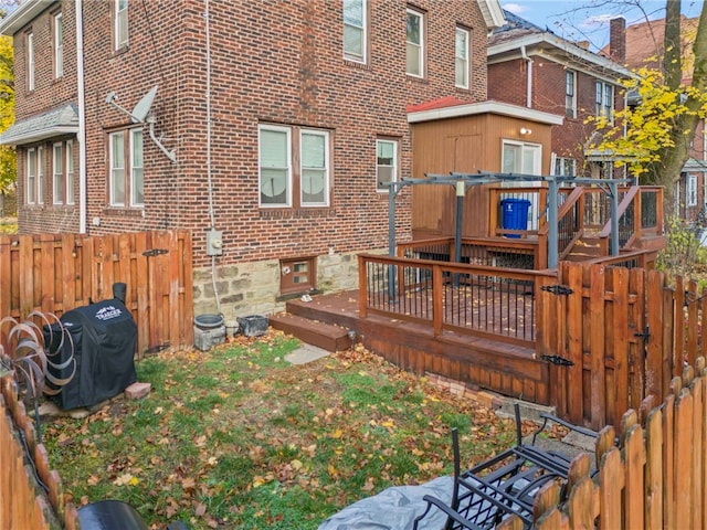 129 S Braddock Ave, Point Breeze, PA 15221 - back of property featuring brick siding, a wooden deck, and fence private yard