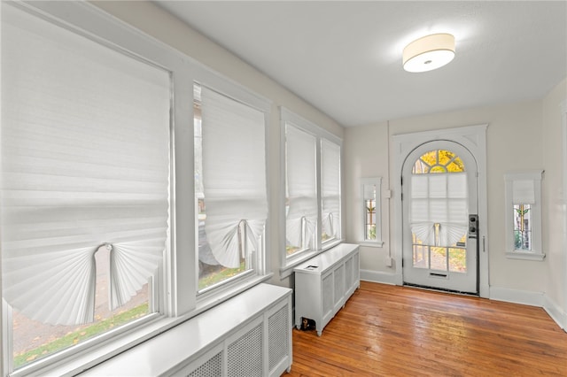 129 S Braddock Ave, Point Breeze, PA 15221 - doorway with radiator heating unit, baseboards, and light wood-type flooring